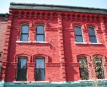 This photo shows the pilasters that separate the bays and the continuous line of projecting brick. 2004; City of Saint John