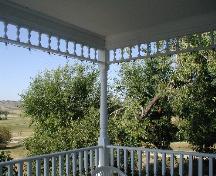 Image of verandah detail in foreground; view of surrounding valley and landscape in background, 2005.; Government of Saskatchewan, Lindy Thorsen, 2005.