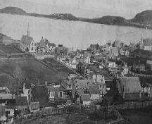Historic view of Trinity, Trinity Bay, NL from Gun Hill, including St. Paul's and Holy Trinity churches, looking towards Trinity Harbour, with Admiral's Point in the background, circa 1950.; Trinity Historical Society Archives