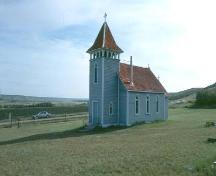 View of Kennell Anglican Church from South-West featuring the typical form and distinctive colours of the church, 1983.; Government of Saskatchewan, Frank Korvemaker, 1983