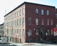 This photograph shows the contextual view of the building and its vast occupancy at the corner of Canterbury and Princess Street, 2004; City of Saint John