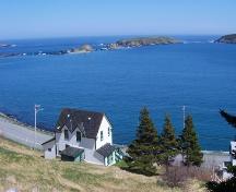 View looking east of Historic Ferryland Museum, Ferryland, NL with Ferryland Harbour in the background. Photo taken May 2006.; HFNL/Andrea O'Brien 2006