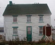 View of the front facade of the Pearce Foley House in Tilting, NL before restoration. ; HFNL 2004