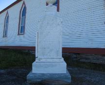 View of Monument to the victims of the 1892 Trinity Sealing Disaster, located within the cemetery of the All Saint's Anglican Church, English Harbour, NL.; HFNL 2005.