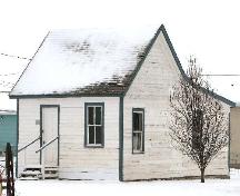 View of Beecher House at the Prairie Pioneer Museum highlighting the small scale and vernacular form of the building, 2006.; Saskatchewan Architectural Heritage Society, Frank Korvemaker, 2006.