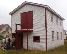 Exterior photo of the Wakeham Sawmill, Placentia, NL, showing main entrance, taken during Doors Open Placentia event, 2004.; HFNL 2005