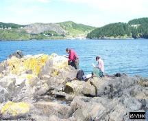 Archaeologists conducting a survey of the shoreline at Blacksmith, Fermeuse, NL. ; Peter Pope 2000/ HFNL 2006