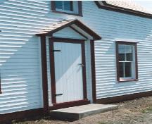 Detail of front door after restoration.  Photo shows storm door - solid plank with two large hinges and typical latch.; HFNL 2004