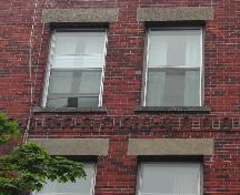 This image provides a view of the decorative band of brick just above the third floor windows, 2005.; City of Saint John