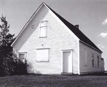 Photo of Former Gayton School showing the two front entrance doors, as well as the partially boarded windows.; Village of Memramcook