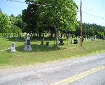 Bard John MacLean Cemetery, with Bard John Maclean's stone rubble monument in the foreground, Glen Bard, Nova Scotia, 2005.; Heritage Division, NS Dept. of Tourism, Culture and Heritage, 2005.