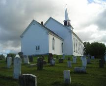 Rear and west elevation and cemetery, St. Peter's Church, Tracadie, Nova Scotia, 2005.
; Heritage Division, NS Dept. of Tourism, Culture and Heritage, 2005.
