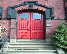 This photograph shows the red door and the elaborate entranceway, 2004; City of Saint John