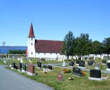 View of St. John the Evangelist Church with cemetery in foreground. Photo taken July 2006.; Kim Barnes/ HFNL 2007