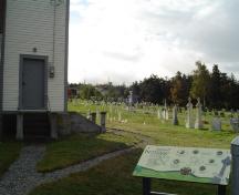 Photo of St. John the Evangelist Cemetery with church in left corner. View looking east, photo taken October 2006.; Kim Barnes/ HFNL 2007