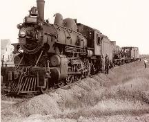 Photo taken at Scotch Settlement in 1946 during a forest fire. The train travelled from Moncton to Bouctouche, making a stop in Saint-Antoine.; Valmond Léger Collection