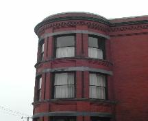 This image shows the upper portion of the three story bay windows and the cornice, 2005.; City of Saint John