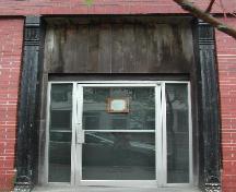 This photograph shows the wooden pilasters and brackets on either side of the north entryway, 2005. ; City of Saint John, 2005
