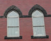 This photograph shows the Gothic arch windows on the third storey of the façade, 2005.; City of Saint John