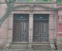 This photograph shows the pedimented entablature with pronounced keystone above the dual entries, 2005.; Cityy of Saint John