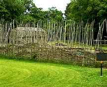 Lawson site reconstructed  palisade and longhouse.; London Museum of Archaeology, 2003