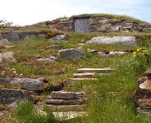 Front photo view of Jim Goodland Upstairs Root Cellar, showing rock stairs ascending from base of hill to cellar, Maberly, Elliston, NL, 2006/06/15; L Maynard, HFNL, 2007