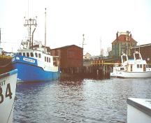 View of the southern end of Grand Bank waterfront with Stoodley Fishing Stage pictured at the centre.  Photo taken 2003.; HFNL 2007