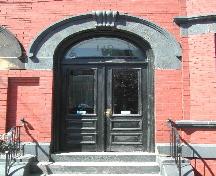 This photograph shows the door and the sandstone roman arch entranceway, 2005; City of Saint John