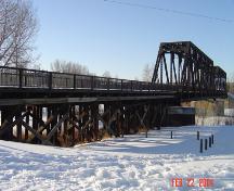 Southeast view showing wood trestle and steel truss construction of the Canadian Pacific Railroad Bridge (February 2004); City of Red Deer, 2004