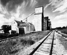 General view of the Inglis elevators, ca.1996.; Heritage Recording and Technical Data Services, HCP, RPS, ''Preliminary Record of 5 Grain Elevators, Inglis, Manitoba'', September/October 1996, photo 07526/23.
