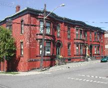 This photograph shows the contextual view of the complex, looking north up Canterbury Street. The Harold Schofield Residence is in the middle of the complex, 2005; City of Saint John