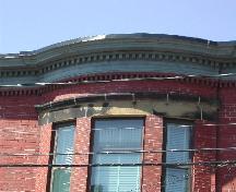 This photograph shows the curved cornice with its dentils and fascia, 2005; City of Saint John