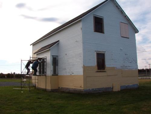 Workers paint the Bay Roberts Railway Station