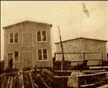 Historic photo image of Fishermen's Protective Union Premises, Doting Cove, Musgrave Harbour, showing store (now Fishermen's Museum) at left, pre-1920; The History of the Fishermen's Protective Union of Newfoundland Collection, Maritime History Archive, Memorial University, St. John's