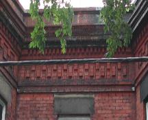 This image provides a view of the cornice ornamented by brick dentils, 2005.; City of Saint John