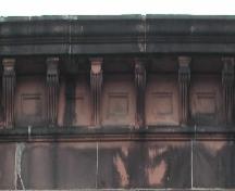 This image shows the stone cornice supported by decorative brackets, 2005.; City of Saint John
