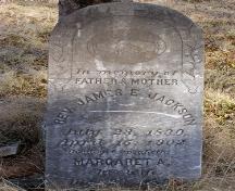 Headstone for Rev. James E. Jackson, an early minister in the community, leaning against a tree in the African Bethel Cemetery, Greenville, Yarmouth, NS, 2008.; Heritage Division, NS Dept. of Tourism, Culture and Heritage, 2008