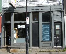 This image provides a view of the storefront, including the wood fascia, pilasters, transom windows, recessed entrance and bulkheads, 2005.; City of Saint John