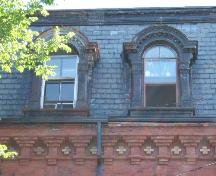 This image provides a view of the roman arched dormers and cornice, 2005.; City of Saint John