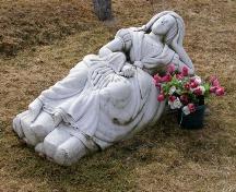 The "Marble Lady" in Chebogue Cemetery, Rockville, Yarmouth County, NS, 2008. The monument was commissioned by Dr. Frederick Webster for his wife Margaret MacNaught Webster.; Heritage Division, NS Dept. of Tourism, Culture and Heritage, 2008