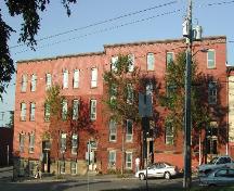 This photograph provides a contextual view of the building on Charlotte Street. This residence is the second unit from the right. 2005.; City of Saint John