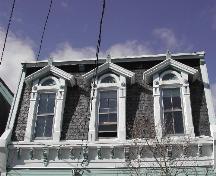 This photograph shows the mansard roof with three dormer windows and the ornate cornice, 2005.; City of Saint John