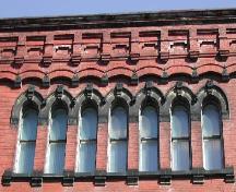 This photograph shows the upper floor windows and the ornate cornice, 2005.; City of Saint John
