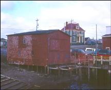 Exterior view of side and front facade, Stoodley Fishing Stage, Grand Bank, NL, under restoration.; 2003 Heritage Foundation of Newfoundland and Labrador