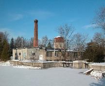 Two-Storey stone mill building, three-storey water tower, brick chimney stack and the mill pond and dam.; Sally Drummond, Town of Caledon