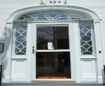 This photograph shows the handsome Neo-classical entrance with circular and diamond pattern in the fan window and sidelights, 2007.; Town of St. Andrews