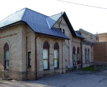 View of the façade depicting the slate hip roof and large arched windows, 2002.; City of Brantford, Department of Planning, 2002.