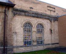 Right side of the front façade depicting large arch windows with multi-light transoms, 2002.; City of Brantford, Department of Planning, 2002.