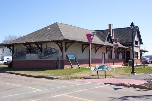 Showing former rail station with mural on the side