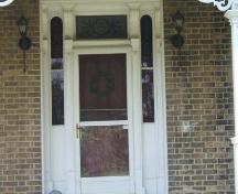 Featured are the red stained glass transom and red stained glass sidelights.; County of Brant, Community and Development Services, 2007.